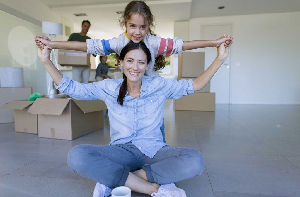 A mother and daughter smiling in front of packed boxes | Idaho Storage Connection