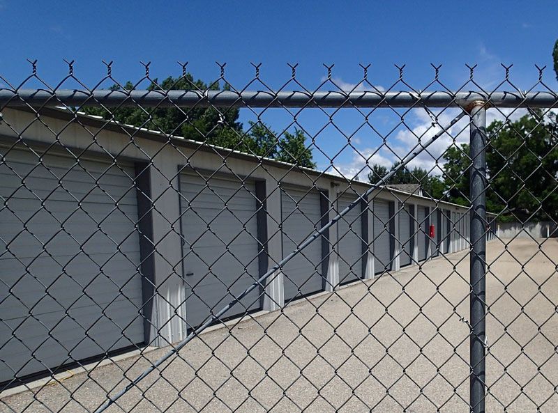 A picture of storage units behind a chain link fence | Idaho Storage Connection