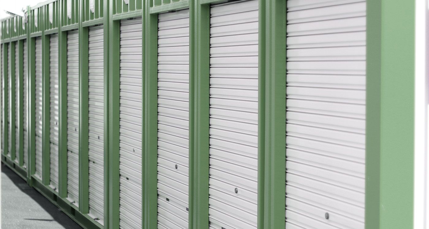 A picture of a row of green storage units | Idaho Storage Connection